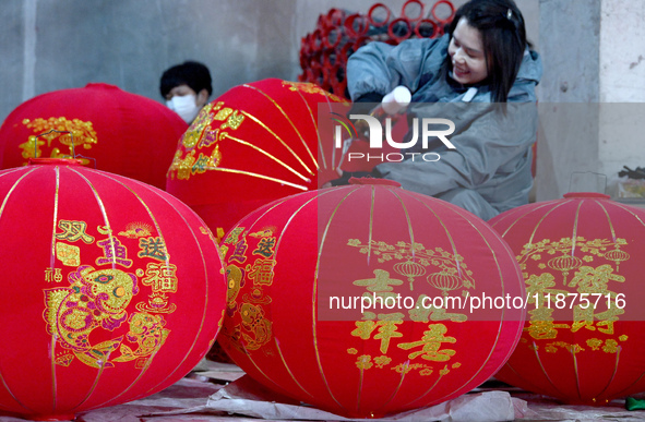 A worker makes red lanterns in Handan, China, on December 17, 2024. 