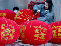 A worker makes red lanterns in Handan, China, on December 17, 2024. (