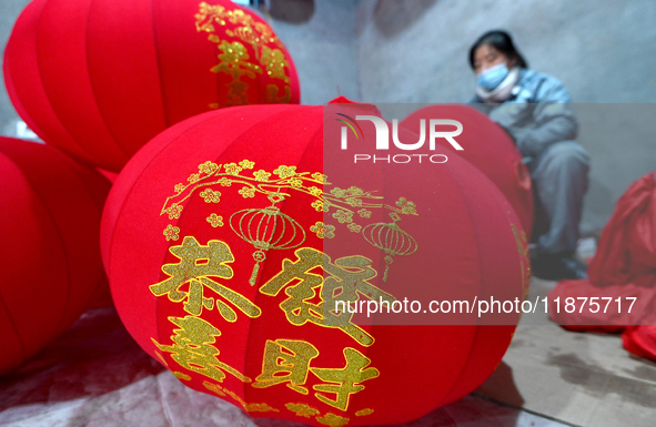 A worker makes red lanterns in Handan, China, on December 17, 2024. 