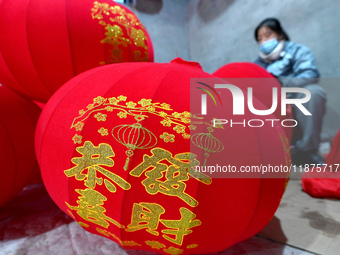 A worker makes red lanterns in Handan, China, on December 17, 2024. (