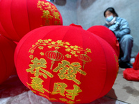 A worker makes red lanterns in Handan, China, on December 17, 2024. (