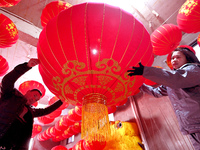 Workers check the quality of red lanterns in Handan, China, on December 17, 2024. (