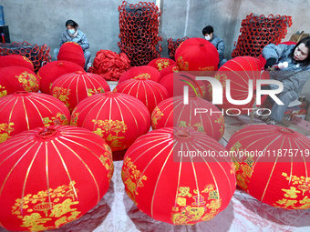 Workers make red lanterns in Handan, China, on December 17, 2024. (