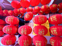 A worker checks the quality of red lanterns in Handan, Hebei province, China, on December 17, 2024. (