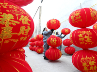 A worker dries red lanterns in Handan, China, on December 17, 2024. (