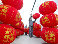 A worker dries red lanterns in Handan, China, on December 17, 2024. (