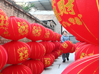 A worker dries red lanterns in Handan, China, on December 17, 2024. (