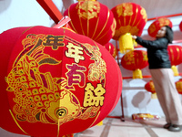 A worker dries red lanterns in Handan, China, on December 17, 2024. (