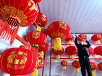 A worker dries red lanterns in Handan, China, on December 17, 2024. (