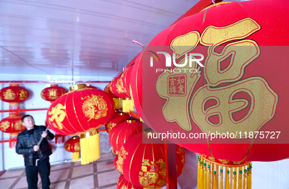 A worker dries red lanterns in Handan, China, on December 17, 2024. 