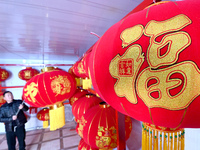 A worker dries red lanterns in Handan, China, on December 17, 2024. (