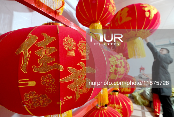 A worker dries red lanterns in Handan, China, on December 17, 2024. 