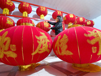 A worker dries red lanterns in Handan, China, on December 17, 2024. (