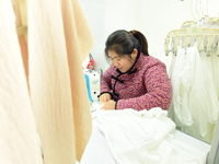 A female worker produces garments for export at a workshop in Lianyungang, China, on December 17, 2024. (