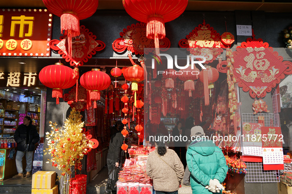 People buy New Year ornaments at Yu Garden Small Commodity Market in Shanghai, China, on December 17, 2024. 