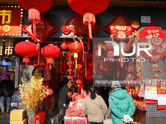 People buy New Year ornaments at Yu Garden Small Commodity Market in Shanghai, China, on December 17, 2024. (