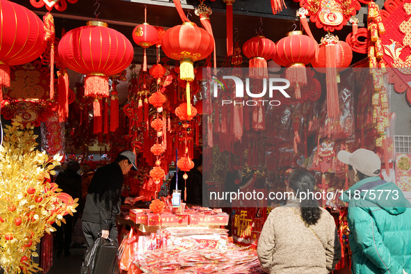 People buy New Year ornaments at Yu Garden Small Commodity Market in Shanghai, China, on December 17, 2024. 