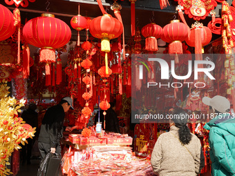 People buy New Year ornaments at Yu Garden Small Commodity Market in Shanghai, China, on December 17, 2024. (