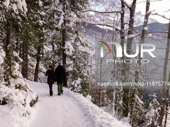 Hikers are at Eibsee in Grainau, Bavaria, Germany, on December 13, 2024. The lake is located 9 km southwest of Garmisch-Partenkirchen below...