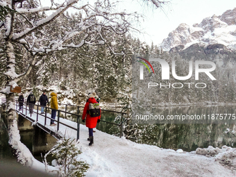 Hikers are at Eibsee in Grainau, Bavaria, Germany, on December 13, 2024. The lake is located 9 km southwest of Garmisch-Partenkirchen below...