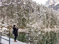 Hikers are at Eibsee in Grainau, Bavaria, Germany, on December 13, 2024. The lake is located 9 km southwest of Garmisch-Partenkirchen below...