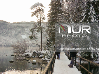 Hikers are at Eibsee in Grainau, Bavaria, Germany, on December 13, 2024. The lake is located 9 km southwest of Garmisch-Partenkirchen below...