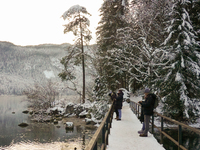 Hikers are at Eibsee in Grainau, Bavaria, Germany, on December 13, 2024. The lake is located 9 km southwest of Garmisch-Partenkirchen below...