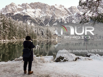 Hikers are at Eibsee in Grainau, Bavaria, Germany, on December 13, 2024. The lake is located 9 km southwest of Garmisch-Partenkirchen below...