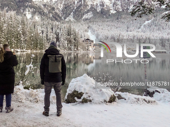 Hikers are at Eibsee in Grainau, Bavaria, Germany, on December 13, 2024. The lake is located 9 km southwest of Garmisch-Partenkirchen below...