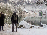 Hikers are at Eibsee in Grainau, Bavaria, Germany, on December 13, 2024. The lake is located 9 km southwest of Garmisch-Partenkirchen below...