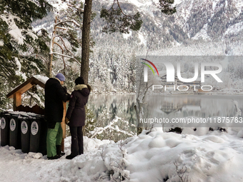 Hikers are at Eibsee in Grainau, Bavaria, Germany, on December 13, 2024. The lake is located 9 km southwest of Garmisch-Partenkirchen below...