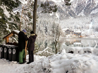 Hikers are at Eibsee in Grainau, Bavaria, Germany, on December 13, 2024. The lake is located 9 km southwest of Garmisch-Partenkirchen below...