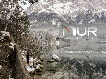 Hikers are at Eibsee in Grainau, Bavaria, Germany, on December 13, 2024. The lake is located 9 km southwest of Garmisch-Partenkirchen below...