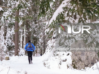 Hikers are at Eibsee in Grainau, Bavaria, Germany, on December 13, 2024. The lake is located 9 km southwest of Garmisch-Partenkirchen below...