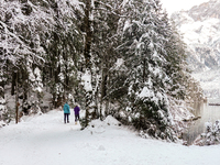 Hikers are at Eibsee in Grainau, Bavaria, Germany, on December 13, 2024. The lake is located 9 km southwest of Garmisch-Partenkirchen below...