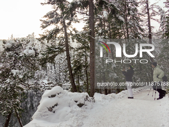 Hikers are at Eibsee in Grainau, Bavaria, Germany, on December 13, 2024. The lake is located 9 km southwest of Garmisch-Partenkirchen below...