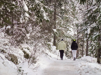 Hikers are at Eibsee in Grainau, Bavaria, Germany, on December 13, 2024. The lake is located 9 km southwest of Garmisch-Partenkirchen below...