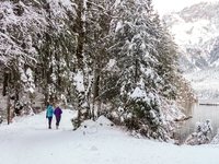 Hikers are at Eibsee in Grainau, Bavaria, Germany, on December 13, 2024. The lake is located 9 km southwest of Garmisch-Partenkirchen below...