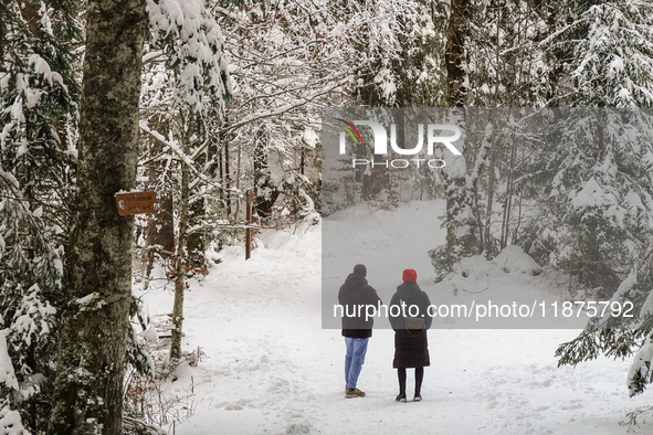 Hikers are at Eibsee in Grainau, Bavaria, Germany, on December 13, 2024. The lake is located 9 km southwest of Garmisch-Partenkirchen below...