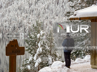 Hikers are at Eibsee in Grainau, Bavaria, Germany, on December 13, 2024. The lake is located 9 km southwest of Garmisch-Partenkirchen below...