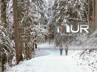 Hikers are at Eibsee in Grainau, Bavaria, Germany, on December 13, 2024. The lake is located 9 km southwest of Garmisch-Partenkirchen below...