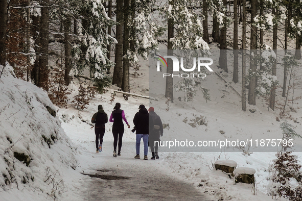 Hikers are at Eibsee in Grainau, Bavaria, Germany, on December 13, 2024. The lake is located 9 km southwest of Garmisch-Partenkirchen below...