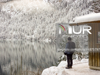 Hikers are at Eibsee in Grainau, Bavaria, Germany, on December 13, 2024. The lake is located 9 km southwest of Garmisch-Partenkirchen below...