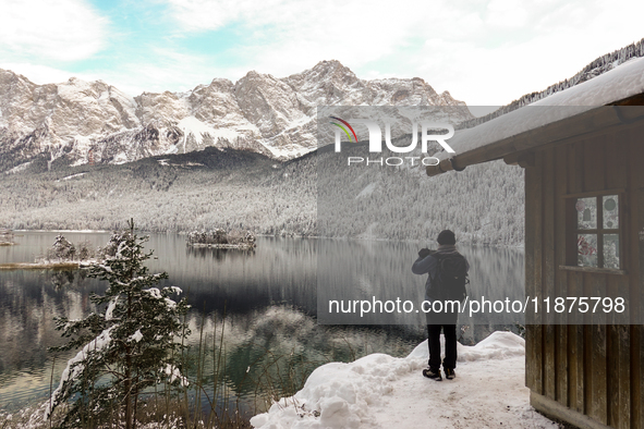 Hikers are at Eibsee in Grainau, Bavaria, Germany, on December 13, 2024. The lake is located 9 km southwest of Garmisch-Partenkirchen below...