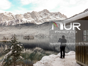 Hikers are at Eibsee in Grainau, Bavaria, Germany, on December 13, 2024. The lake is located 9 km southwest of Garmisch-Partenkirchen below...