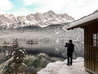 Hikers are at Eibsee in Grainau, Bavaria, Germany, on December 13, 2024. The lake is located 9 km southwest of Garmisch-Partenkirchen below...