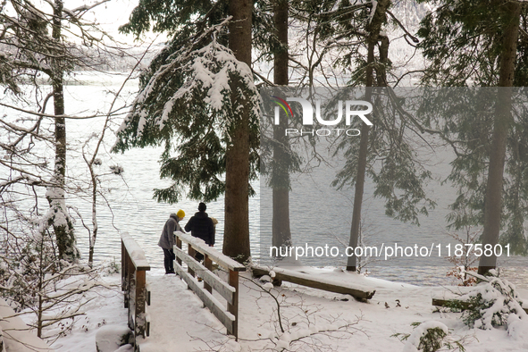 Hikers are at Eibsee in Grainau, Bavaria, Germany, on December 13, 2024. The lake is located 9 km southwest of Garmisch-Partenkirchen below...