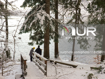 Hikers are at Eibsee in Grainau, Bavaria, Germany, on December 13, 2024. The lake is located 9 km southwest of Garmisch-Partenkirchen below...