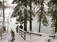 Hikers are at Eibsee in Grainau, Bavaria, Germany, on December 13, 2024. The lake is located 9 km southwest of Garmisch-Partenkirchen below...