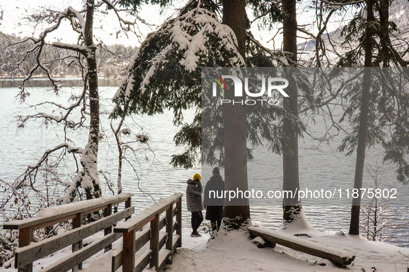 Hikers are at Eibsee in Grainau, Bavaria, Germany, on December 13, 2024. The lake is located 9 km southwest of Garmisch-Partenkirchen below...